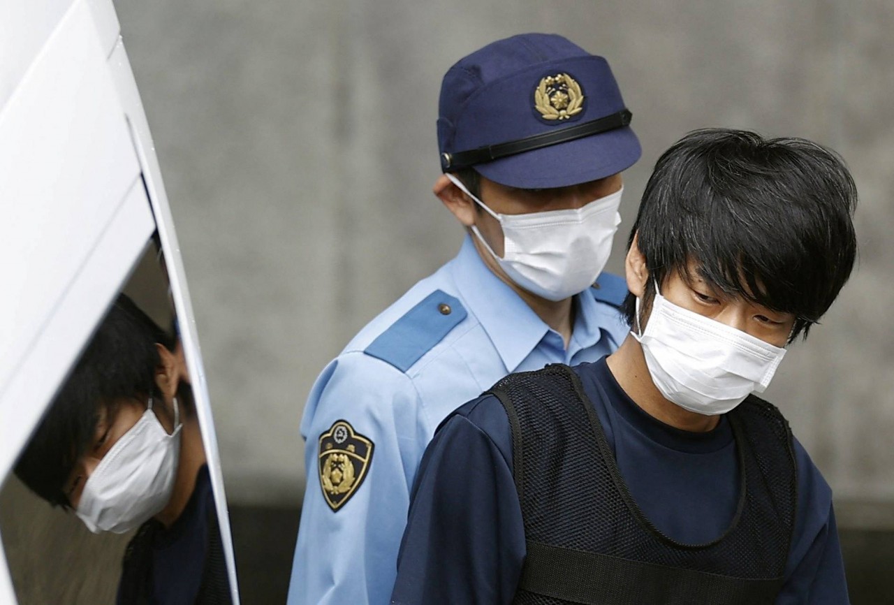 Tetsuya Yamagami, suspected of killing former Prime Minister Shinzo Abe, is escorted by a police officer in Nara on July 10. | KYODO