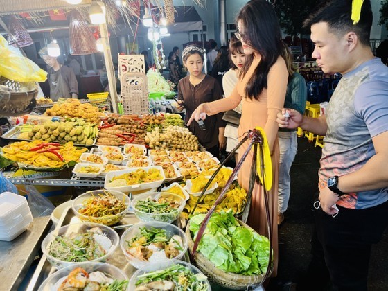 Visitors experience dishes at a cuisine booth.