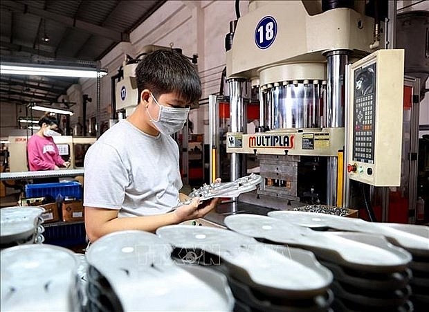 Producing shoe components at a foreign-invested company, in Thuan An city, Binh Duong province. (Photo: VNA)