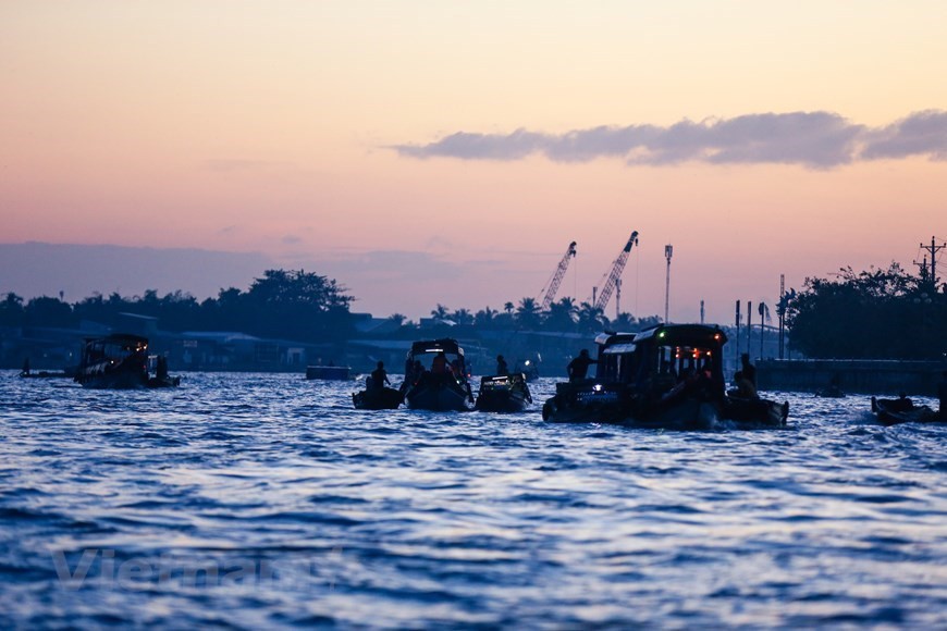 As soon as first rays of the sun hit, boats with signature agriculture products of the Mekong Delta area gather at the Cai Rang floating market (Photo: VNA)