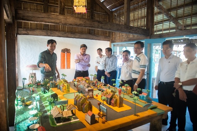 Visitors at the Driftwood Village in Cẩm Hà Commune, Hội An. The site displays a collection of more than 100 sculptures from recycled firewood and debris. — Photo courtesy of Ngọc Thuận