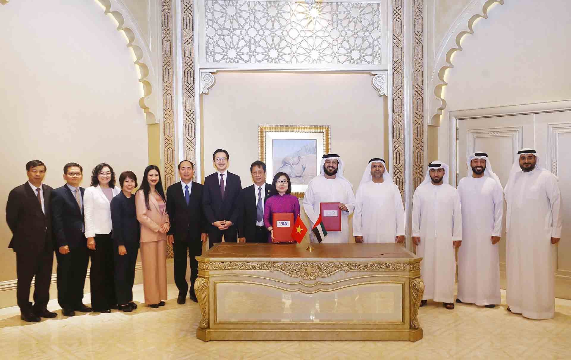 Phó Tổng giám đốc Thông tấn xã Việt Nam Đoàn Thị Tuyết Nhung và Tổng giám đốc Hãng thông tấn Emirates (WAM) của UAE Mohamed Jalal Al Rayssi ký Thỏa thuận hợp tác nghiệp vụ. (Nguồn: TTXVN)