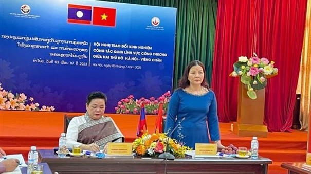 Hanoi, Vientiane share experience in State management in industry, trade