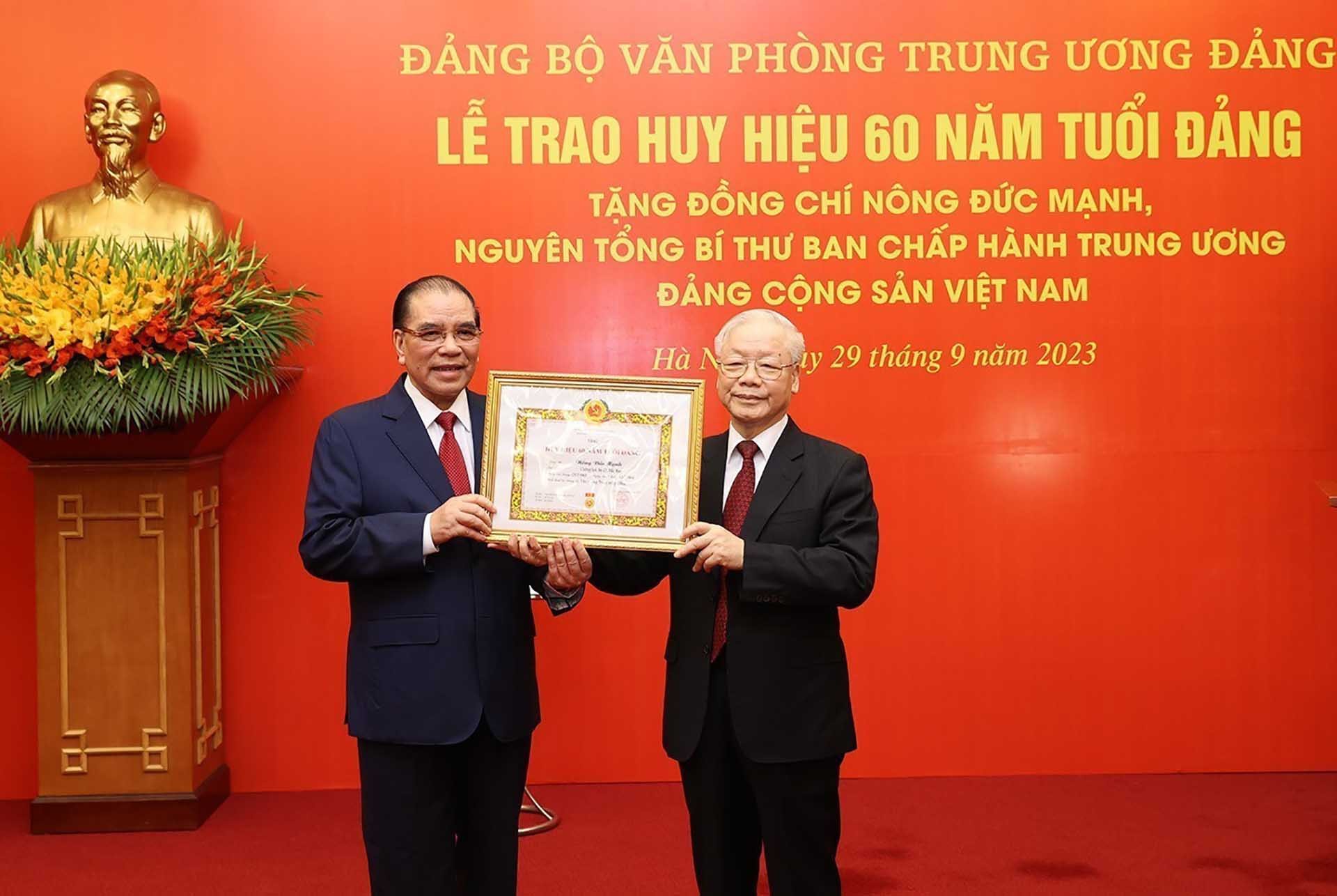 Tổng Bí thư Nguyễn Phú Trọng trao Huy hiệu 60 năm tuổi Đảng cho nguyên Tổng Bí thư Nông Đức Mạnh. (Nguồn: TTXVN)