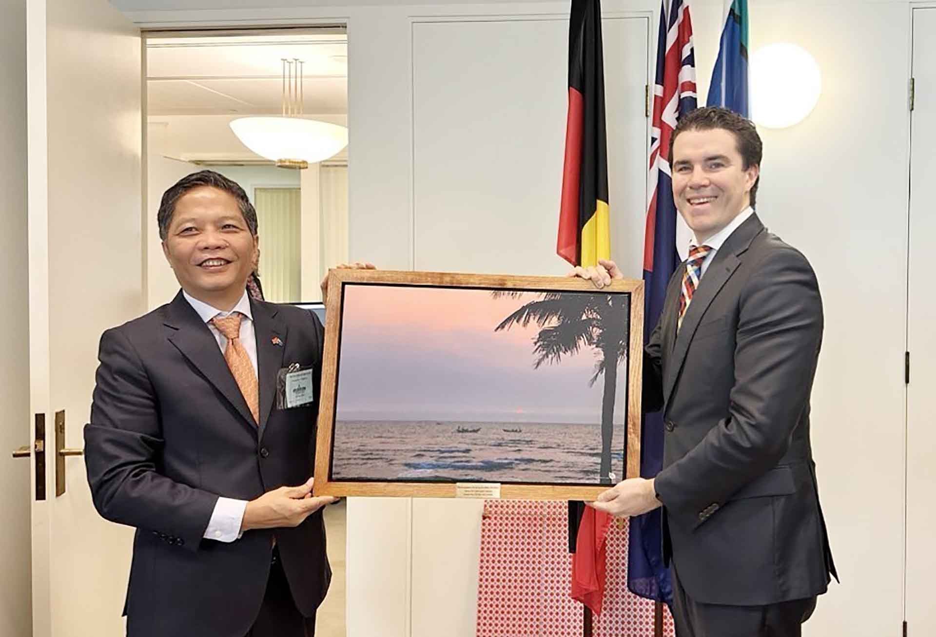 Trưởng ban Kinh tế Trung ương Trần Tuấn Anh tặng quà lưu niệm đồng Bộ trưởng Ngoại giao Australia Tim Watts. (Nguồn: TTXVN)