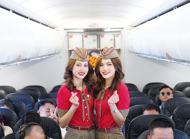 Vietjet’s cabin crews welcome passengers on board.