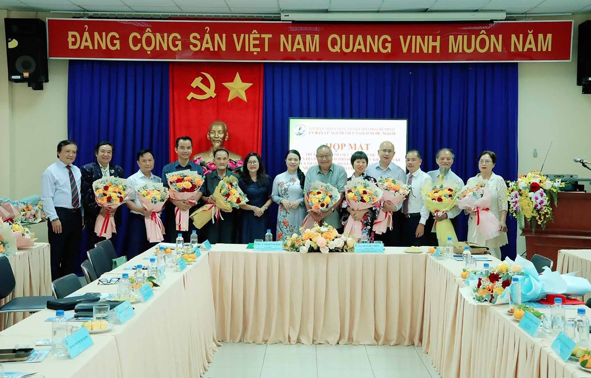 Chủ nhiệm Ủy ban về NVNONN TP. Hồ Chí Minh Vũ Thị Huỳnh Mai (đứng giữa) tặng hoa cho các đại biểu có đóng góp hiến kế cho Thành phố. (Ảnh: NVCC)