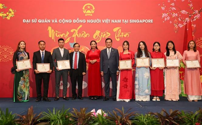 Đại sứ Mai Phước Dũng trao Giấy khen cho các cá nhân trong cộng đồng người Việt và Hội sinh viên Việt Nam tại Singapore. Ảnh: Lê Dương - Pv TTXVN tại Singapore