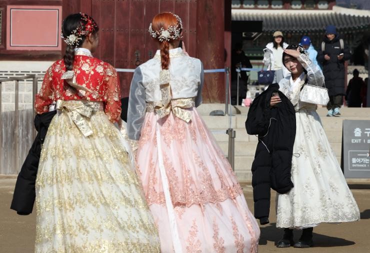 Travelers dressed in Korea's traditional attire hanbok visit Gyeongbok Palace in central Seoul, Sunday. Yonhap