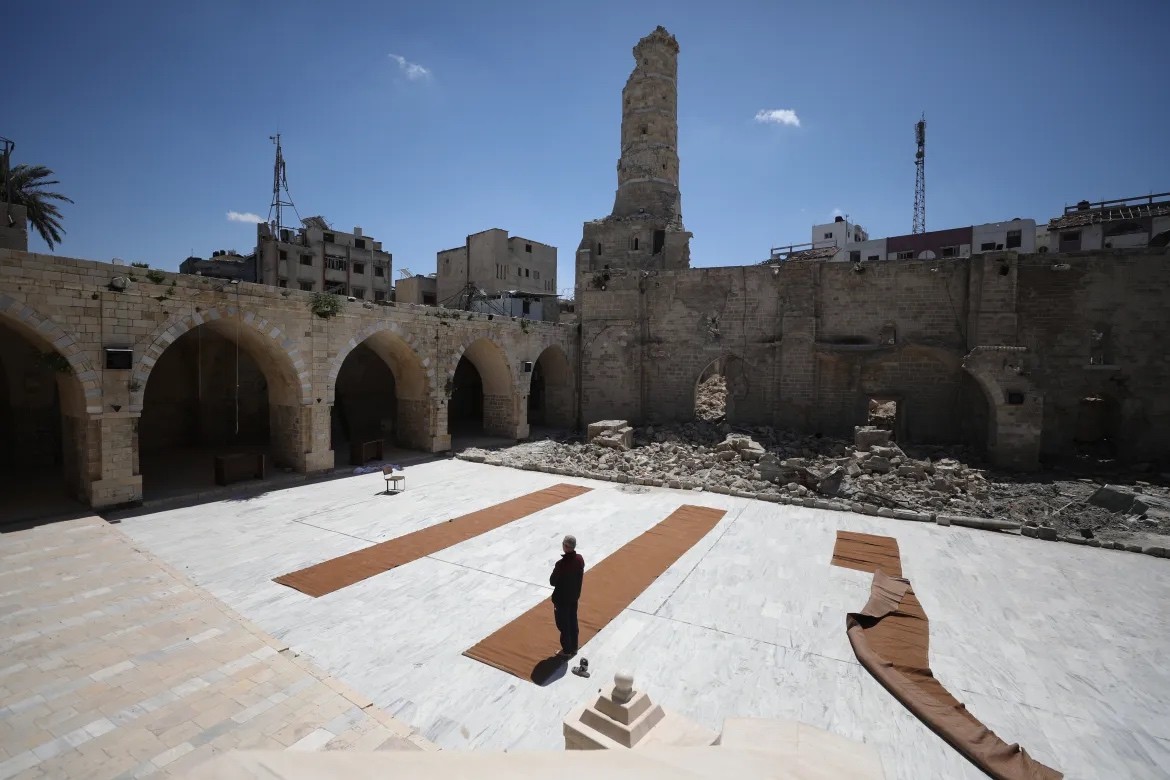 The Great Mosque nằm một phần trong đống đổ nát khi người Palestine tụ tập để đọc Kinh Qur'an trong những ngày cuối cùng của tháng Ramadan, tại thành phố Gaza. [Dawoud Abo Alkas/Anadolu]