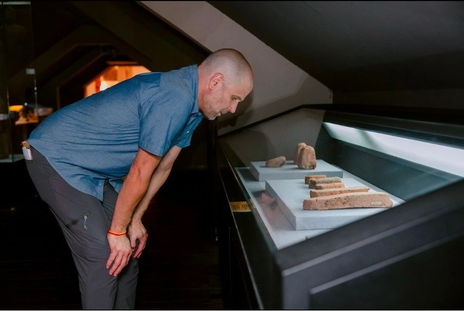 Assoc. Prof. Shannon Gramse gazes upon artifacts from centuries past.