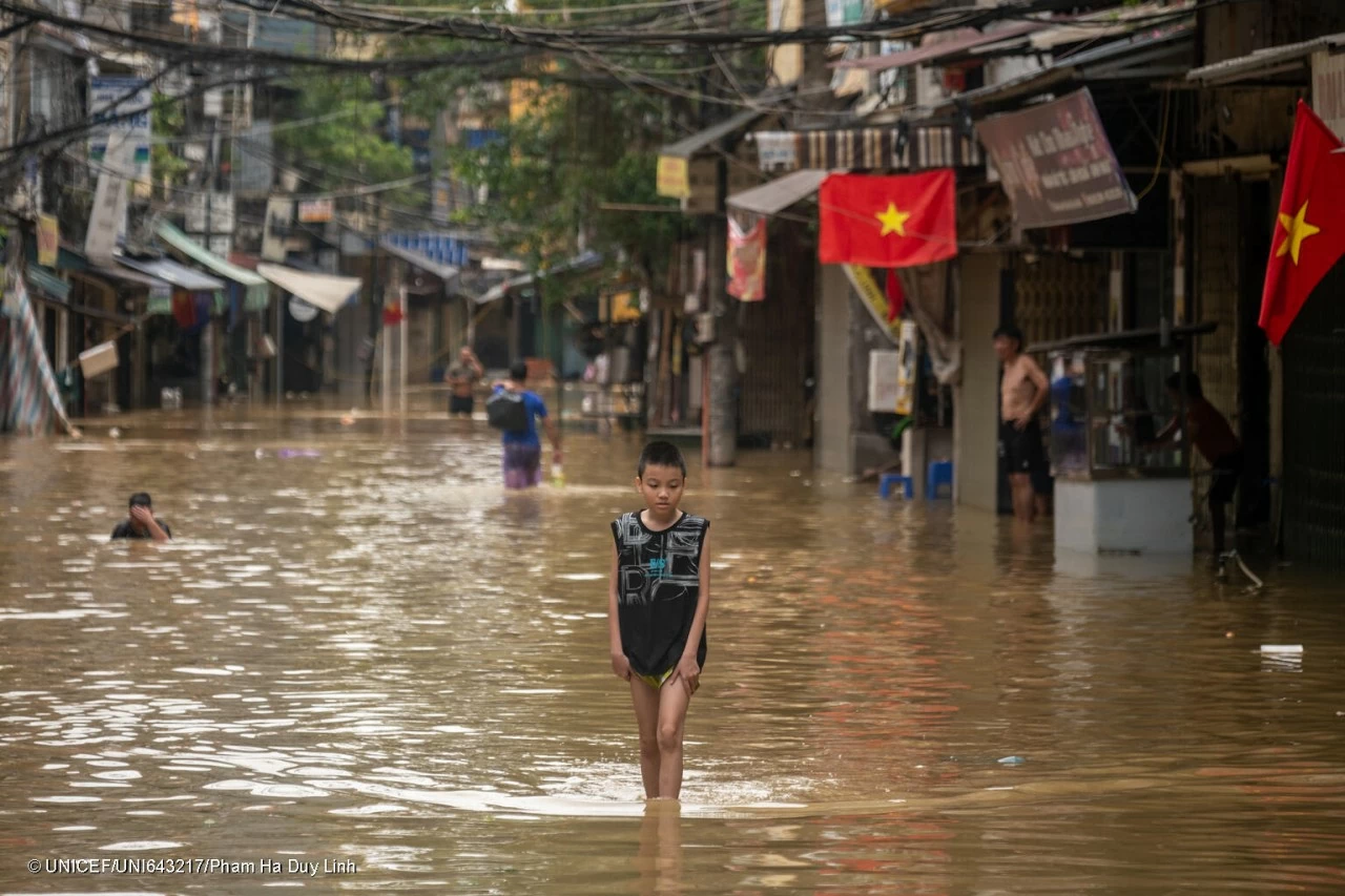 Nguyễn Tiến Lâm, 11, walks near his house at a neighborhood near the Red River, which is flooded following Typhoon Yagi on September 11, 2024, in Hanoi, Vietnam. (PhotoL UNICEF Vietnam)