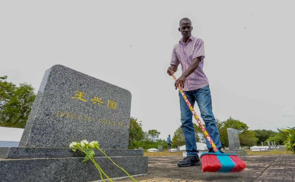 Một công nhân quét sạch nghĩa trang Gongo la Mboto ở Dar es Salaam, Tanzania, vào ngày 12 tháng 8, trong số các bia mộ cho các kỹ sư, kỹ thuật viên và công nhân Trung Quốc đã chết trong khi xây dựng tuyến đường sắt của Cơ quan Đường sắt Tanzania-Zambia (Nguồn: Tân hoa xã) Một công nhân quét sạch nghĩa trang Gongo la Mboto ở Dar es Salaam, Tanzania, vào ngày 12 tháng 8, trong số các bia mộ cho các kỹ sư, kỹ thuật viên và công nhân Trung Quốc đã chết trong khi xây dựng tuyến đường sắt của Cơ quan Đường sắt Tanzania-Zambia (Nguồn: Tân hoa xã)