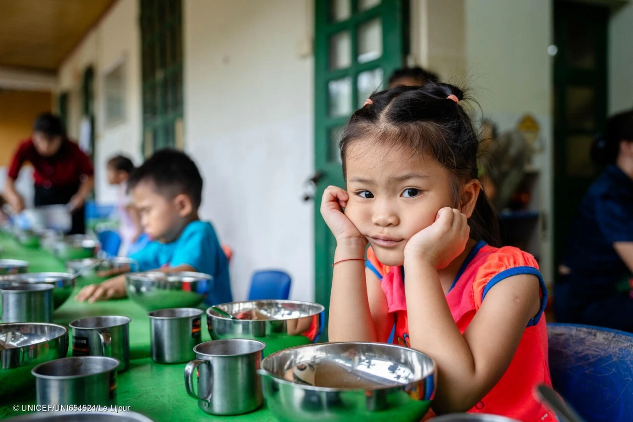 A child waits to eat after playing with toys of the UNICEF-supplied Early Childhood Education Kit in a kindergarten in Nu village, one of the hardest hit villages by Typhoon Yagi in Vietnam. (Photo: UNICEF)