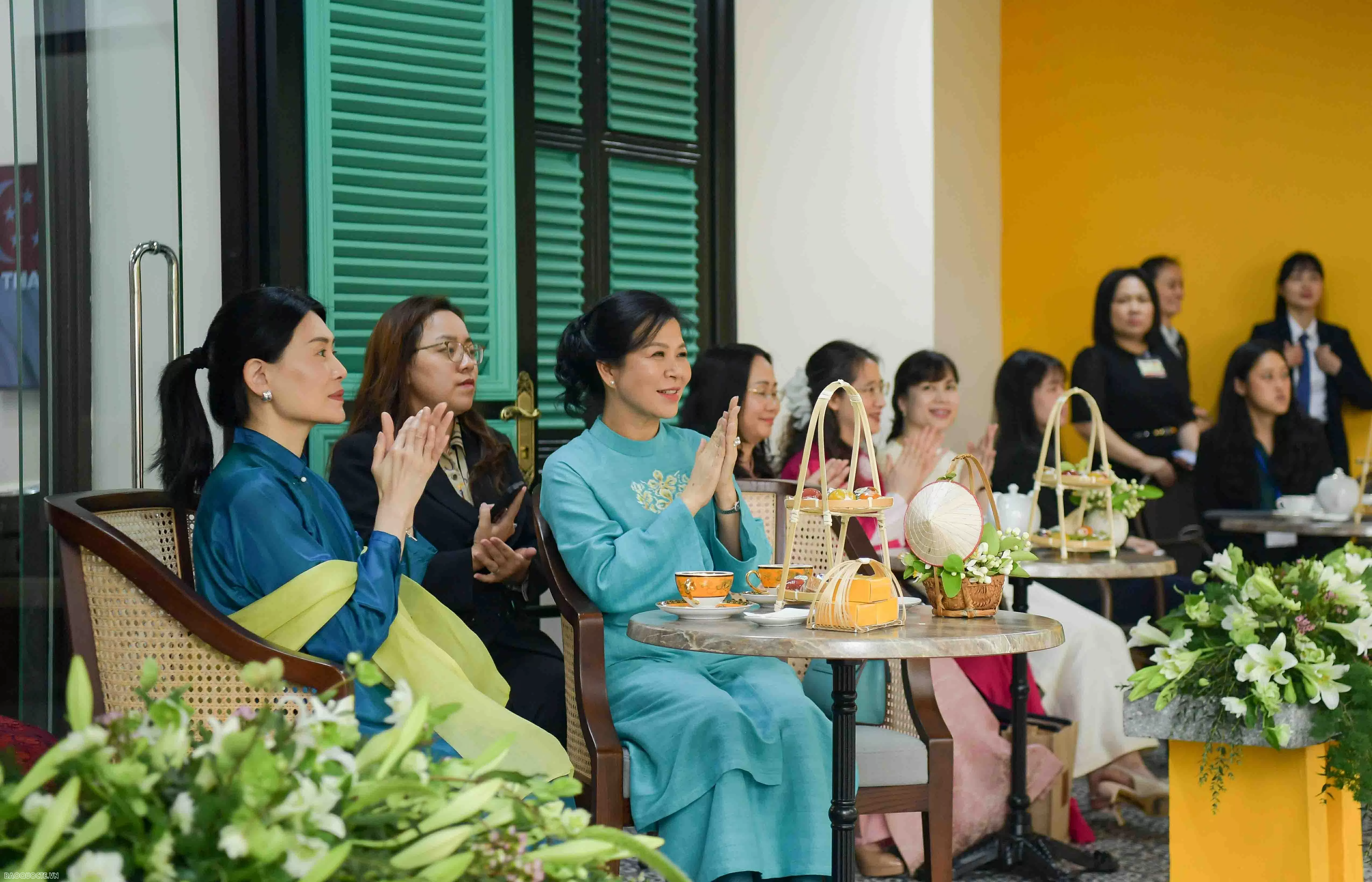 Spouses of Party leader, Singaporean Prime Minister contemplate water puppetry