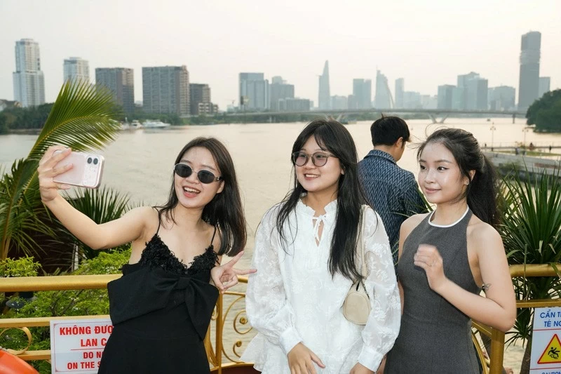 Du khách trẻ trải nghiệm du thuyền ngắm hoàng hôn trên sông Sài Gòn.