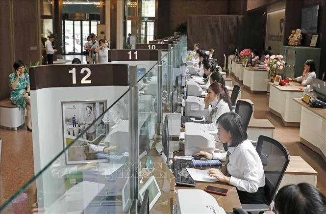 Giao dịch tại Hội sở chính Vietcombank 198 Trần Quang Khải. (Nguồn: TTXVN) Giao dịch tại Hội sở chính Vietcombank 198 Trần Quang Khải. (Nguồn: TTXVN)
