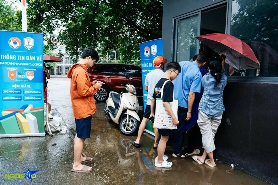 Người hâm mộ xếp hàng dưới trời mưa to để mua vé xem trận tuyển Việt Nam và Singapore
