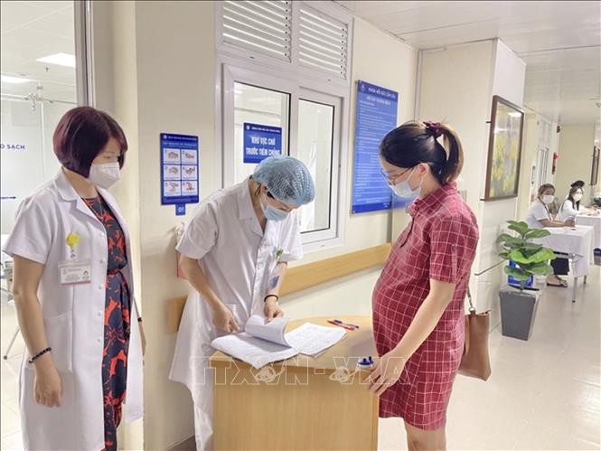 Sản phụ đến khám, đăng ký tiêm vaccine phòng COVID-19 tại bệnh viện Phụ sản Trung ương. 
