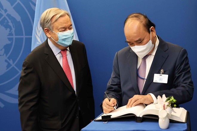 ghi Sổ lưu niệm tại cuộc gặp Tổng thư ký Liên hợp quốc, Antonio Guterres. (Nguồn: TTXVN)