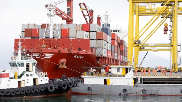 Containers are loaded onto a ship at Tien Sa port in Da Nang city, March 2020.    © Reuters