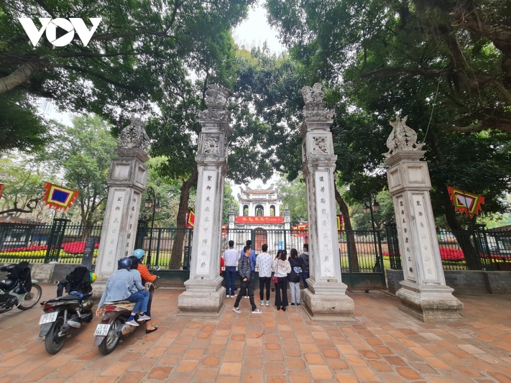 Local people perform a worship ritual outside of the Temple of Literature.