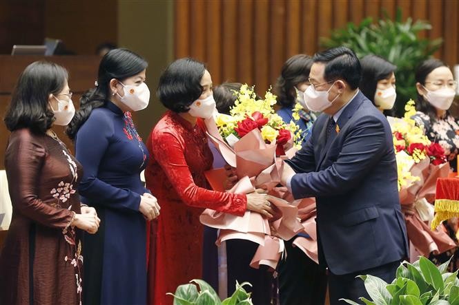 Chủ tịch Quốc hội Vương Đình Huệ trao Nghị quyết và tặng hoa Nhóm nữ đại biểu Quốc hội, ngày 8/11/2021. (Nguồn: TTXVN)