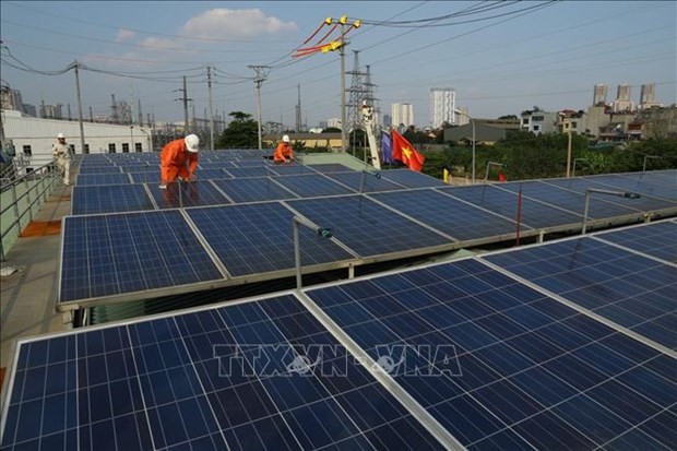 Solar panels on the roof of a building (Source: VNA)