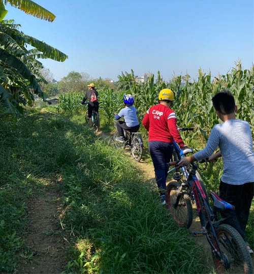 Children ride bicycles to explore the surroundings of Lau Island as part of the ‘Red River Experience’ tour, developed by Anytrails Company. (Photo courtesy of Anytrails Company)