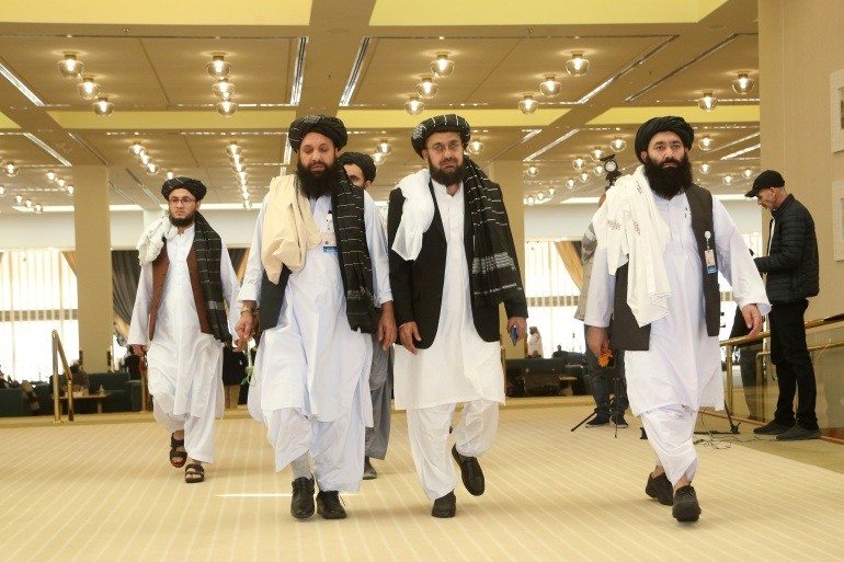 A Taliban delegation arrives for the agreement signing between Taliban and US officials in Doha [File: Hussein Sayed/AP]