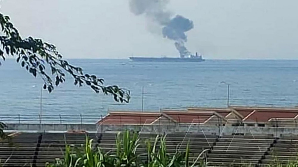 A handout picture released by the official Syrian Arab News Agency (SANA) on April 24, 2021 shows smoke billowing from a tanker off the coast of the western Syrian city of Banias - SANA/AFP