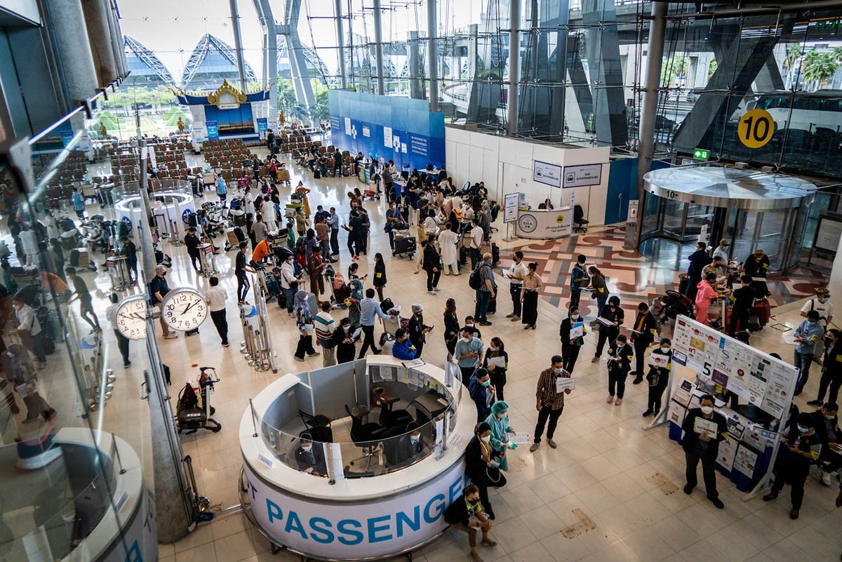 Tourists shuffle through the”Test and Go” pre-quarantine area of the arrivals hall at Suvarnabhumi International Airport (BKK) before being taken to their hotel to await PCR test results. (Photo by Matt Hunt/SOPA Images/LightRocket/Getty Images)