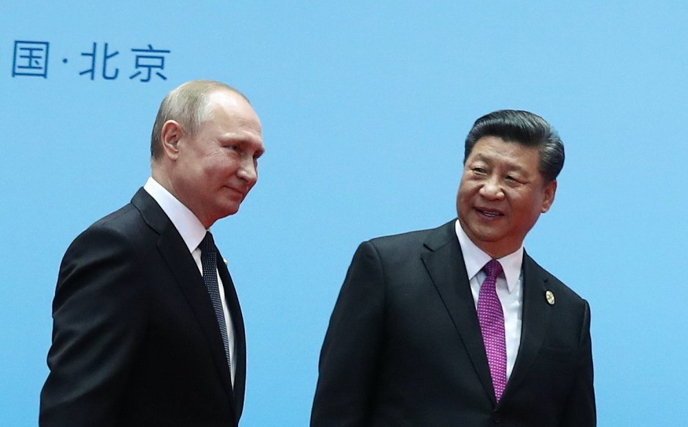 Chinese President Xi Jinping (right) and Russian President Vladimir Putin smile during the welcoming ceremony on the final day of the Belt and Road Forum in Beijing, on April 27, 2019. VALERY SHARIFULIN/SPUTNIK/AFP VIA GETTY 