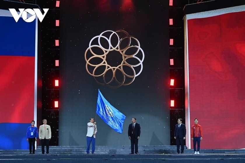 A Cambodian official receives the SEA Games flag to host the games in 2023