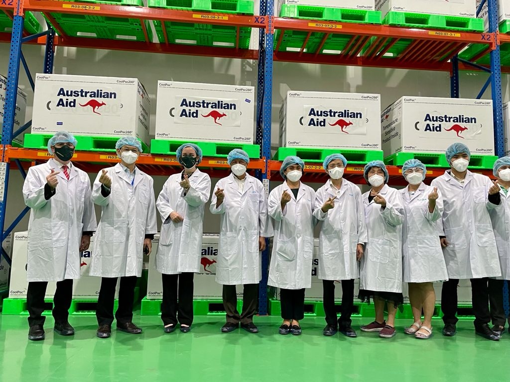 Australian and Vietnamese officials celebrate the first delivery of 403,000 COVID-19 AstraZeneca doses from Australia