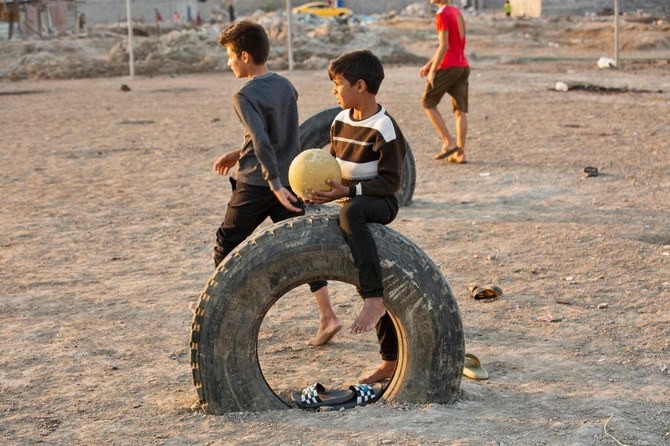 Iraqi children play football near the International Stadium in Iraq's southern city of Basra, on December 1, 2021. (File/AFP)