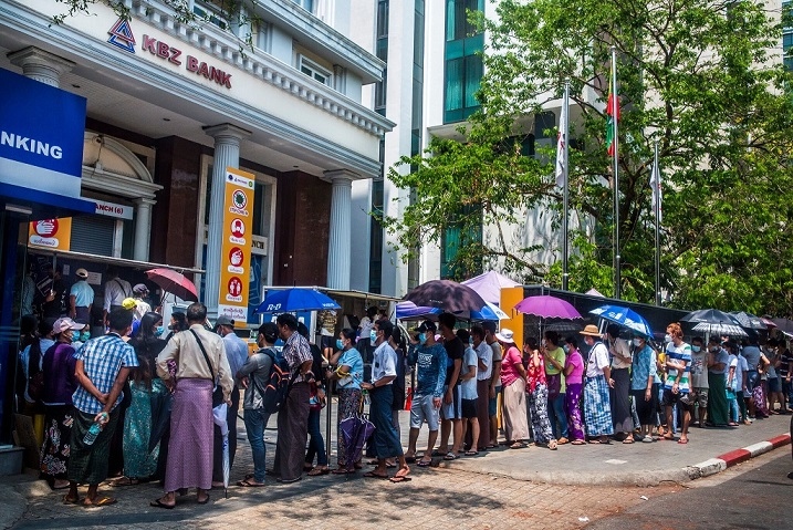 Người dân xếp hàng để rút tiền mặt ở Yangon, Myanmar, vào tháng Ba. Kể từ khi quân đội nắm chính quyền trong một cuộc đảo chính sáu tháng trước, quốc gia Đông Nam Á này đã phải quỳ gối vì thiếu tiền mặt nghiêm trọng.Tín dụng...
