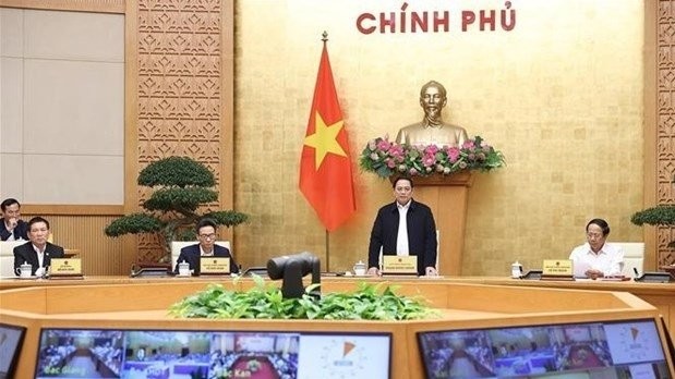 Prime Minister Pham Minh Chinh (standing) chairs the national teleconference on March 5. (Photo: VNA)