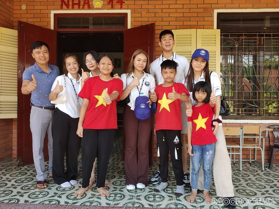 (07.21) Thanh niên, kiều bào trẻ chụp ảnh lưu niệm cùng trẻ em làng trẻ SOS Vinh. (Ảnh: Minh Quân)