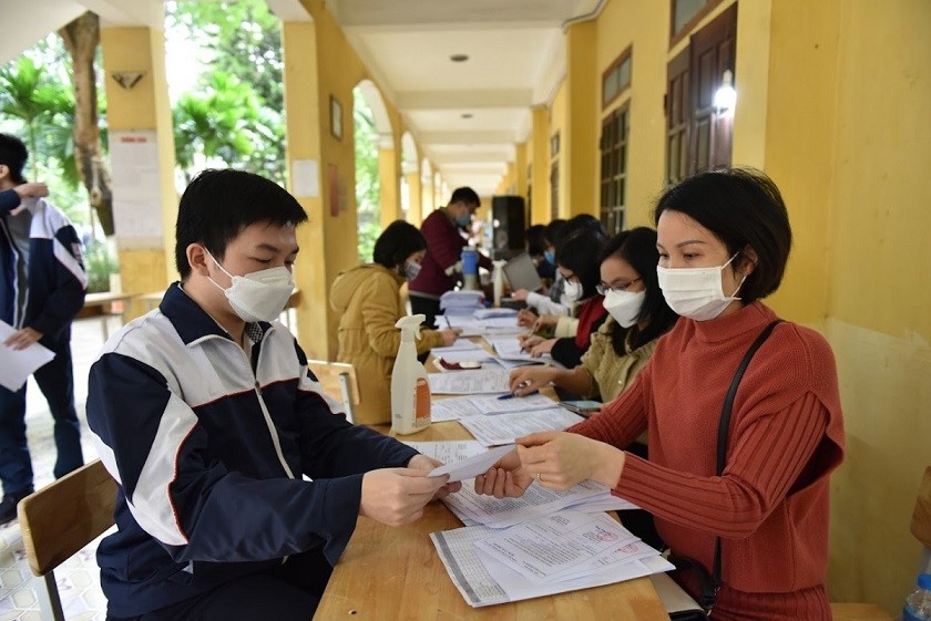 Học sinh Hà Nội sau khi tiêm vaccine phòng Covid-19 được nhận giấy xác nhận đã tiêm mũi một. (Nguồn: ngoisao.net)