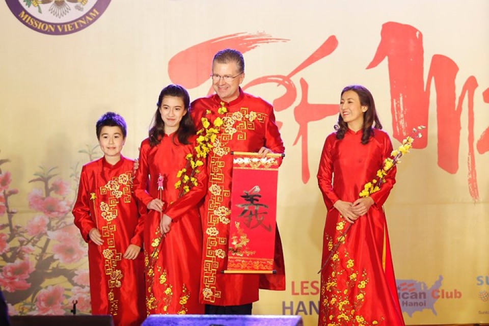 us ambassador his family wear red ao dai to embassy tet event