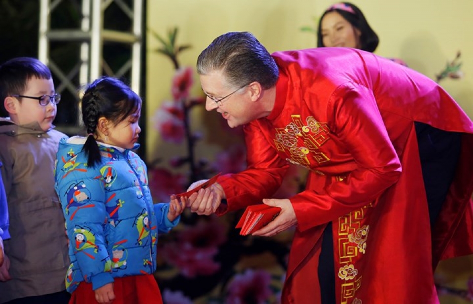 us ambassador his family wear red ao dai to embassy tet event