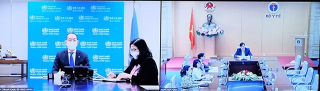 Minister of Health Nguyễn Thanh Long and World Health Organization (WHO) Regional Director for the Western Pacific Takeshi Kasai held talks on Friday. — Photo suckhoedoisong.vn