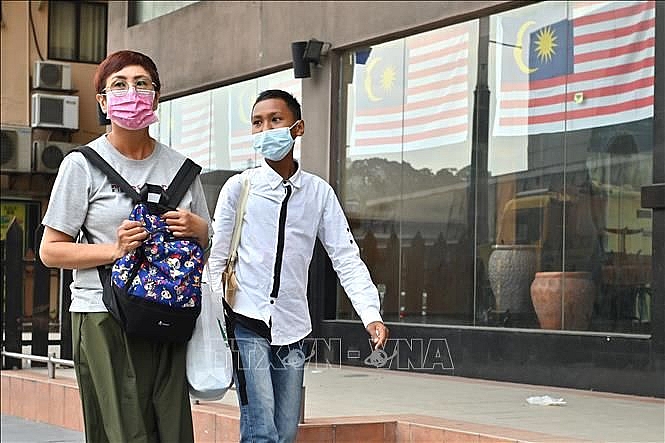 Người dân đeo khẩu trang phòng lây nhiễm COVID-19 tại Kuala Lumpur, Malaysia ngày 9/12. (Nguồn: TTXVN)